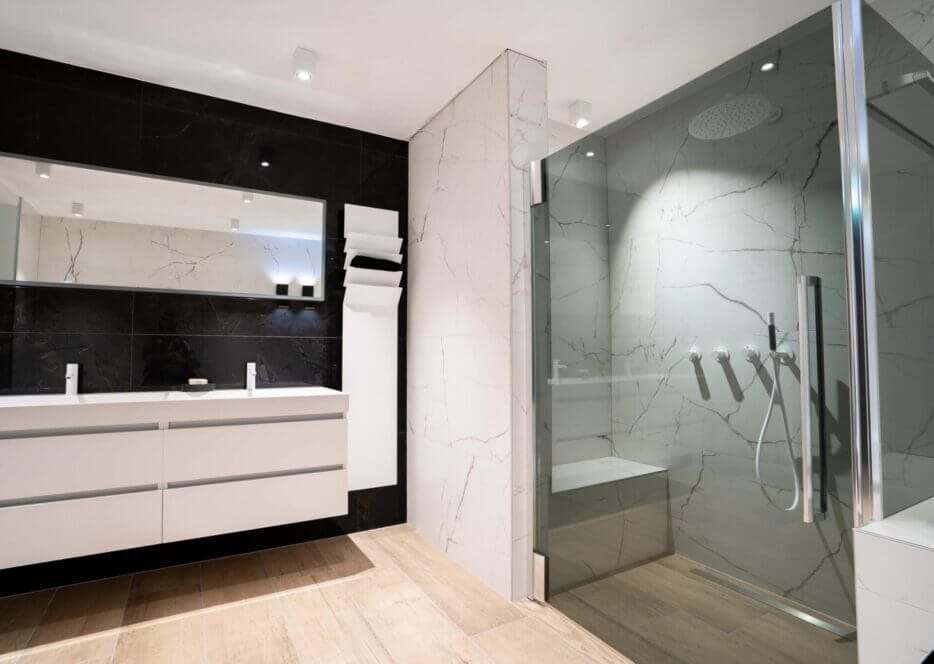 Bathroom with white marble walls and white luminaires at the ceiling