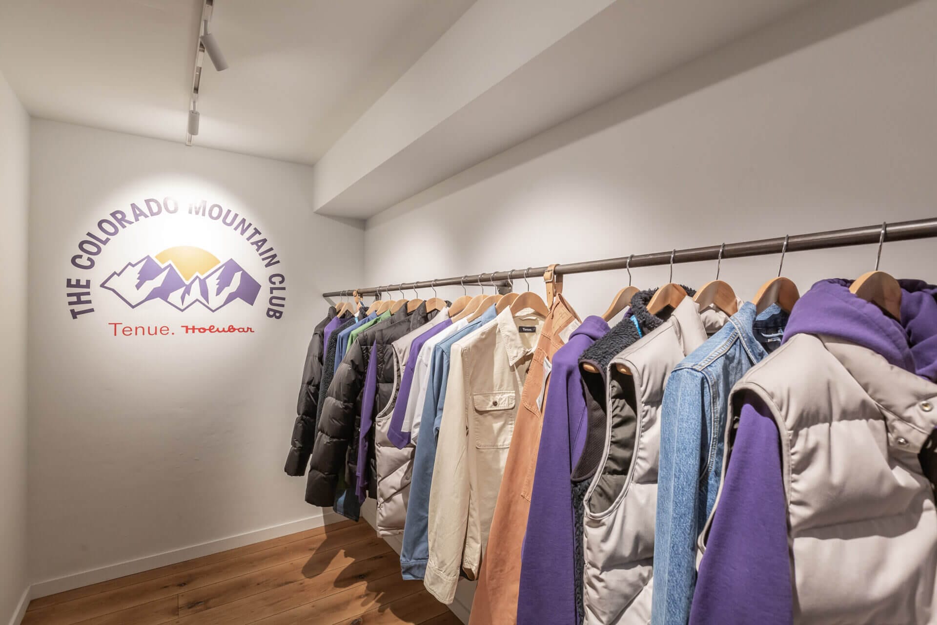 rack with clothes end logo lit up with Dea Juno spotlight