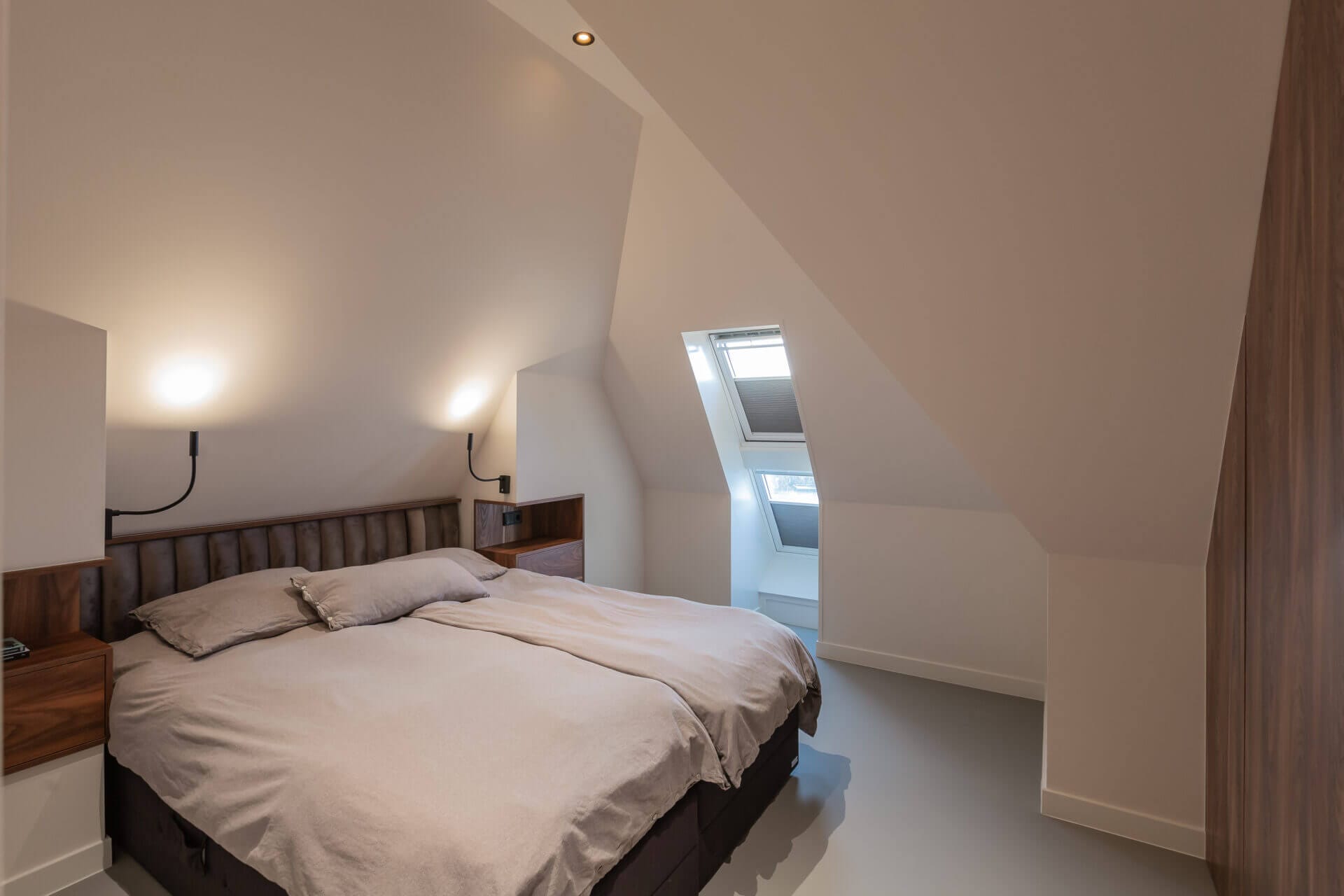 Bedroom with slanted ceiling and recessed lighting