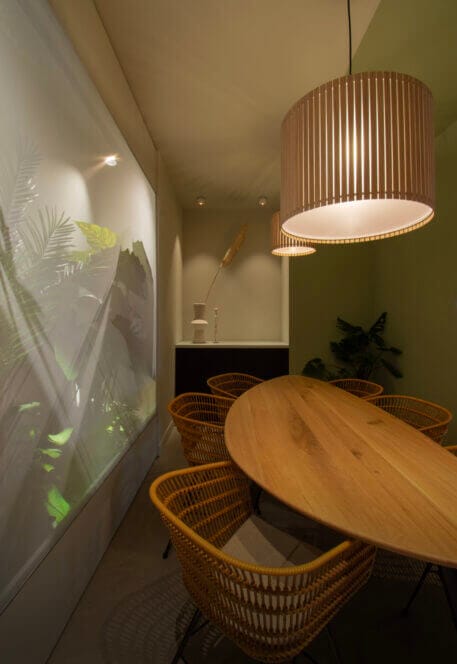 Meeting room with oval table and leave wallpaper on wall