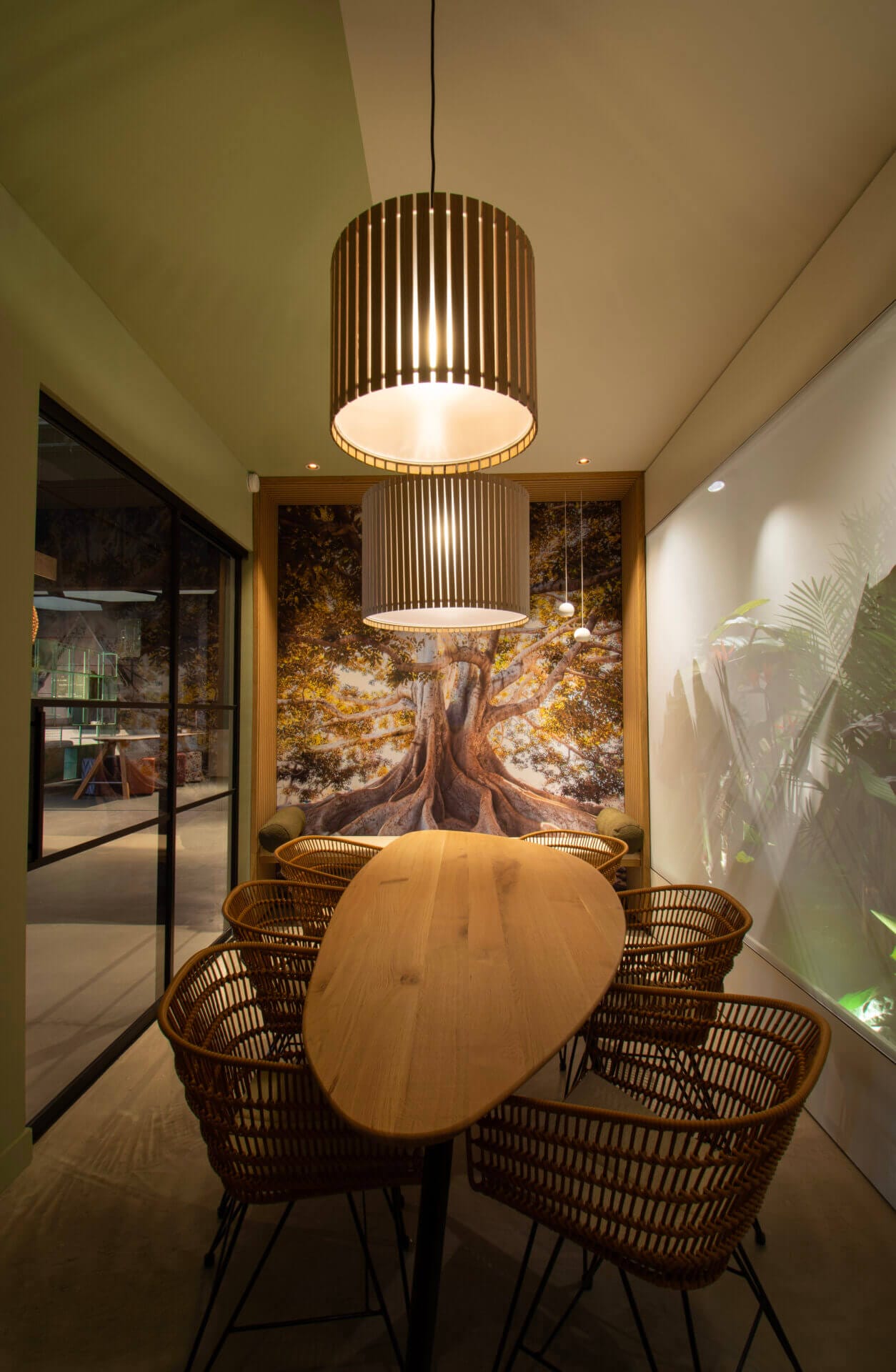 Meeting room natural bohemian style with oval table and tree wallpaper