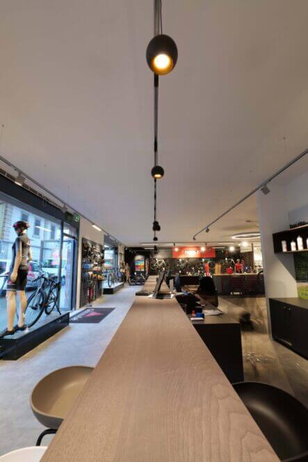 Dea Eros track luminaires above counter of a shop