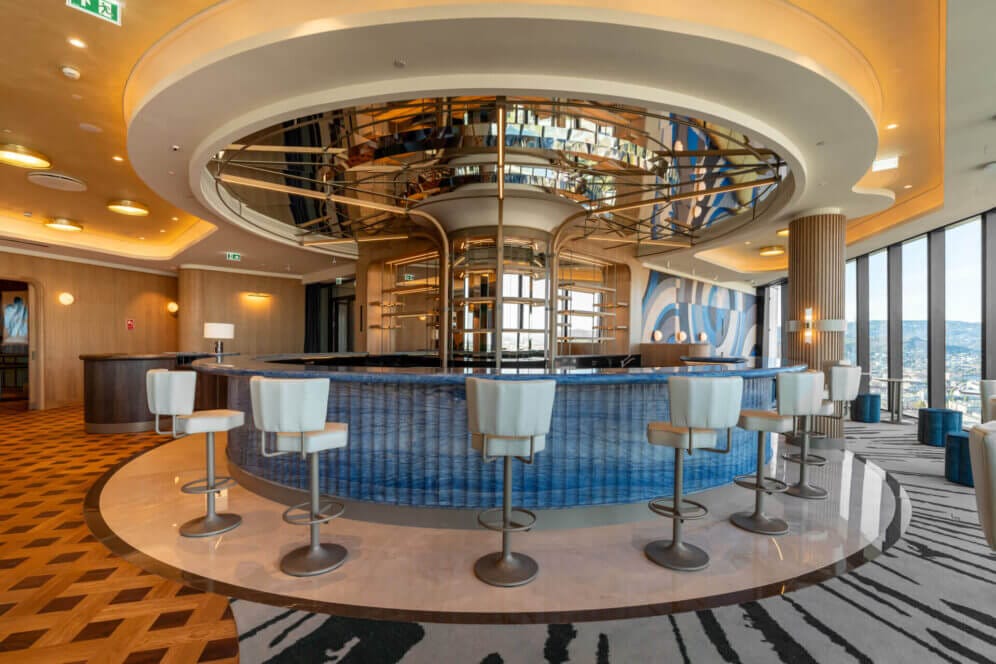 Round bar with blue tiles and white chairs
