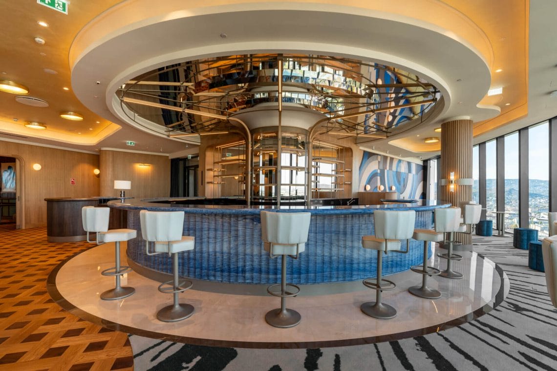 Round bar with blue tiles and white chairs
