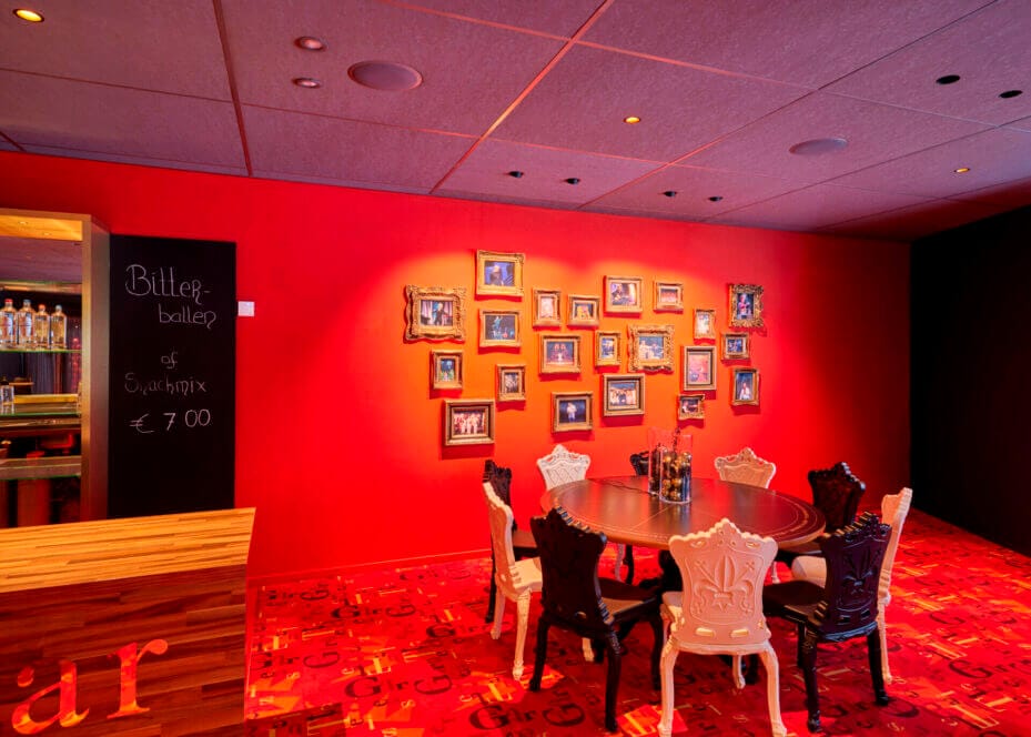 Theatre interior with a red wall with photo frames.