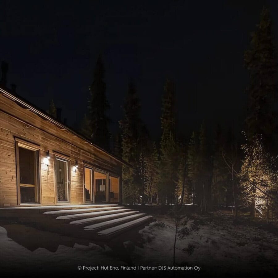 Finnish wooden cabin in the snow with outdoor lighting Artemis by Karizma Luce.