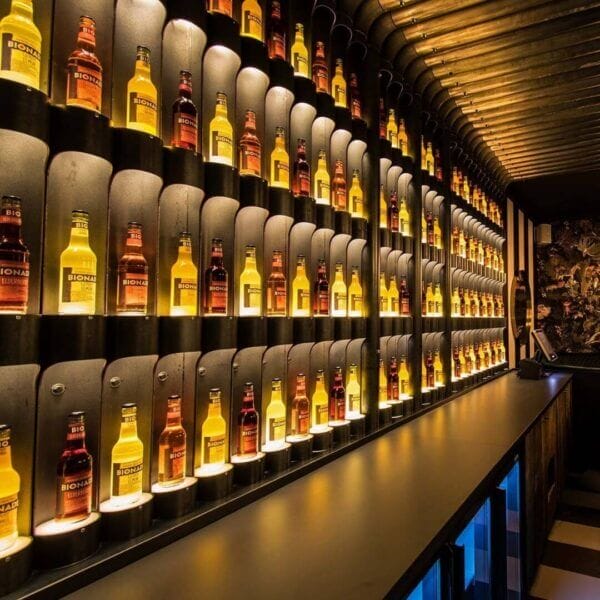 Bar with bottles that are individually lighted up by Karizma Luces Dea Amata XS.