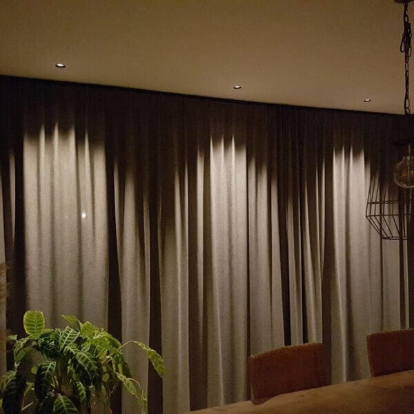 Dea Diana XS lighting up curtains making beam angles visible.