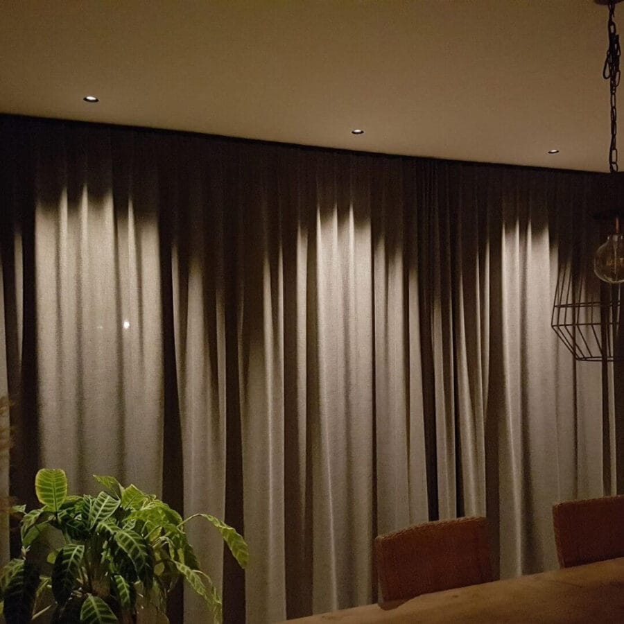 Dea Diana XS lighting up curtains making beam angles visible.