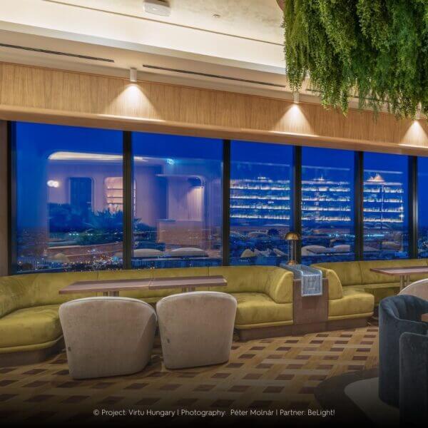 Dea Cura S lighting up with a clear beam above windows with a view over the city.