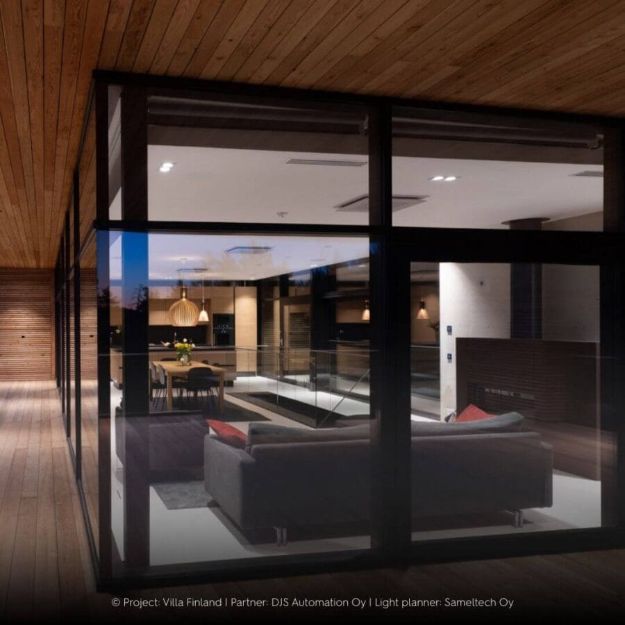 Complete interior of penthouse with big windows and industrial look with doppio luminaire in the ceiling.