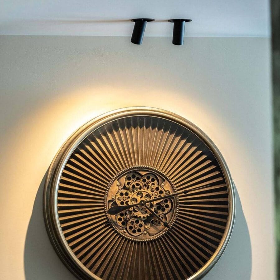 Dea Fontana S in ceiling lighting up big clock.
