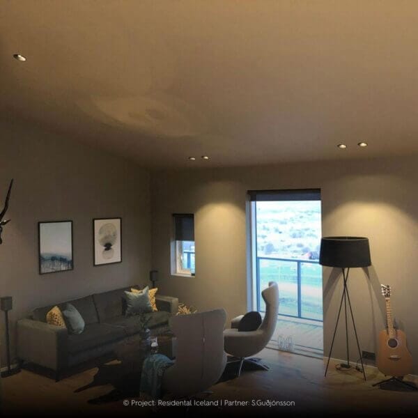 Living room with slanted ceiling and recessed Popolare luminaires.