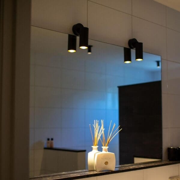 Vuoto surface luminaire placed above mirror.