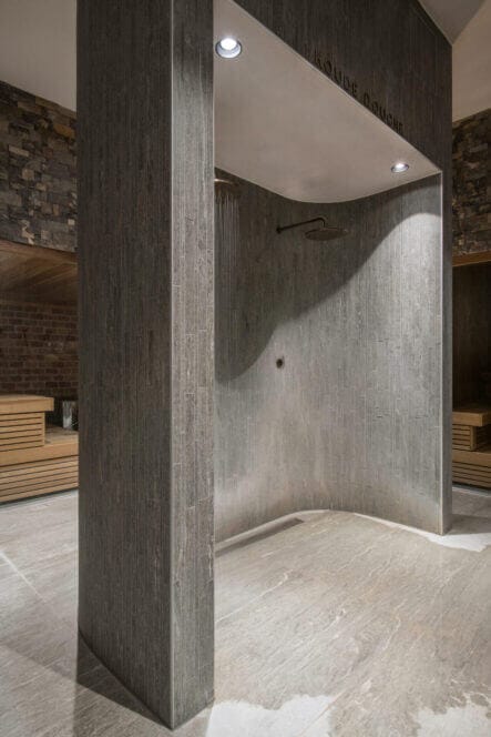 Shower at simmingpool with concrete wall