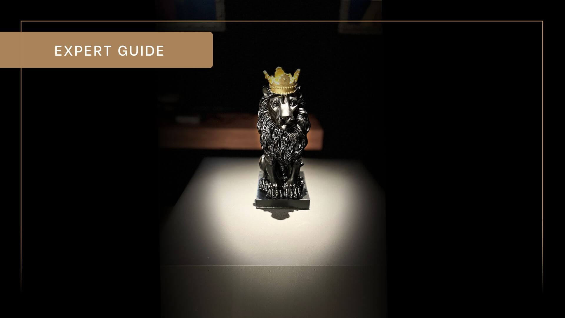 Spotlight on small statue of a lion.